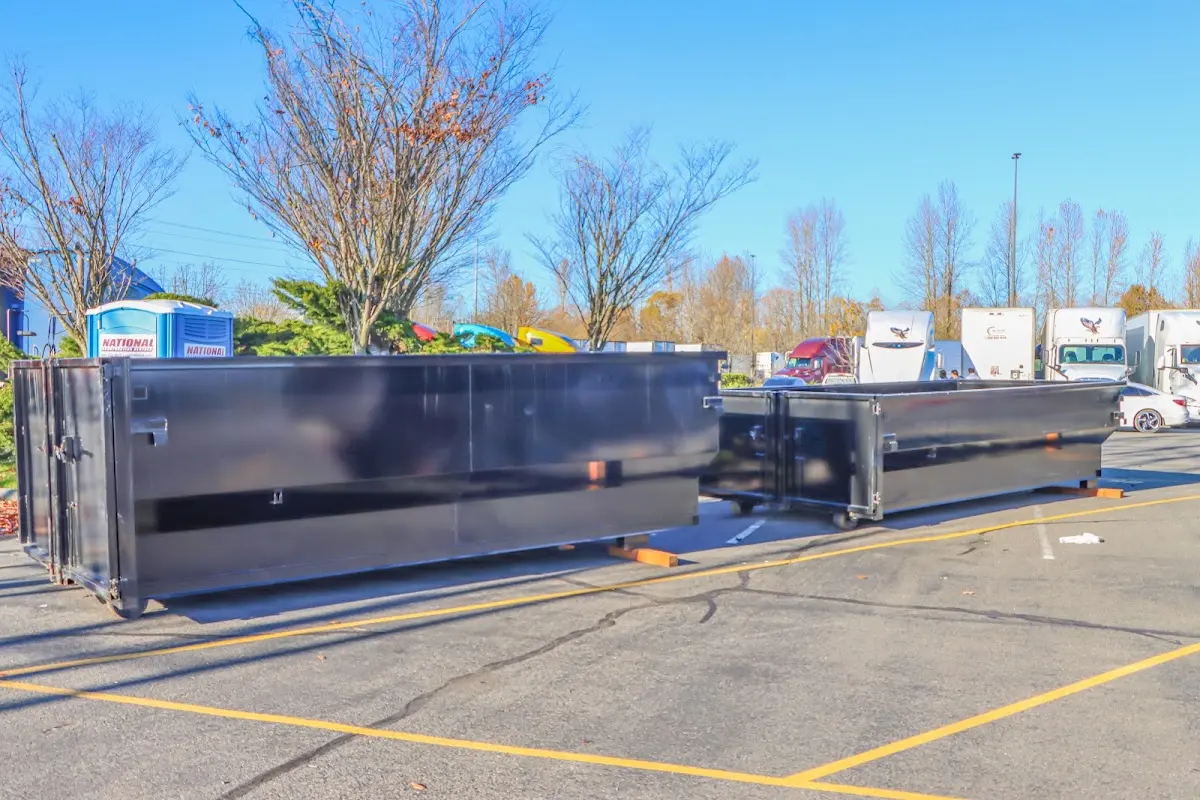 Professional dumpster rental service with roll-off container on residential driveway in Ephrata